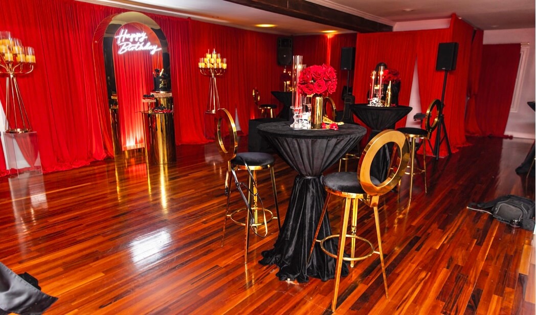 Room draping with pops of gold, red, black